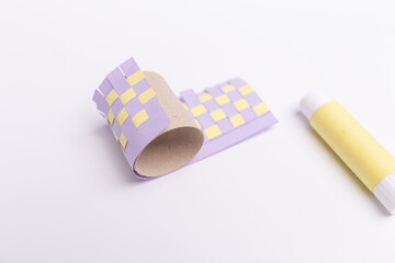 DIY spring holiday craft for kids, colored strips for making paper baskets, activity for childrens, recycled toilet paper roll