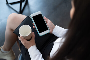 Girl using smartphone with blank screen copy space screen for your text message or information content