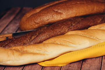 sliced loaf yellow napkin wooden table baked goods