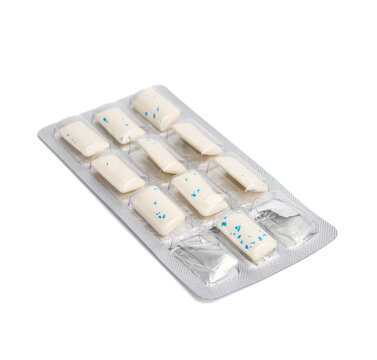 rectangular pieces of gum in a blister pack on a white background
