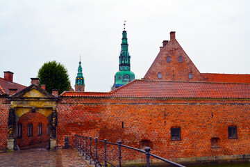 Arched gate to Frederiksborg castle complex in Hillerod, Denmark. Medieval brick architecture. 