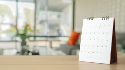 white paper desk calendar on wood table with blurred bokeh background appointment and business meeting concept - obrazy, fototapety, plakaty