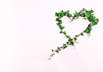 Creative layout made of branches and leaves with copy space. Flat lay. Heart shape. Love concept