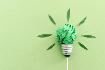Concept image if green crumpled paper lightbulb, symbol of scr, innovation and eco friendly business