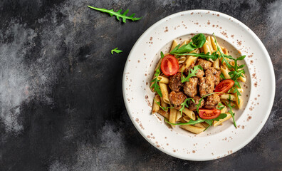 penne pasta with meatballs and tomato sauce. italian pasta. gray background. banner, menu recipe place for text, top view