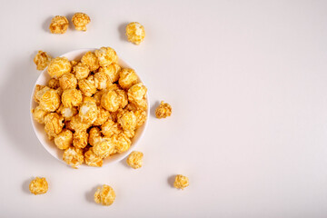 Popcorn on a white plate in a white plate. View from above