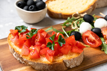 Italian bruschetta with tomatoes, olive oil, green parsley. typical Italian antipasti starter in restaurant in Italy Rome Milan. Mediterranean diets food. 