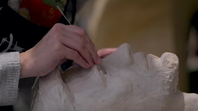 The process of creating sculpture. The sculptor is working. Plaster molding and restoration.