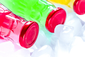 plastic bottles with fruit juice and ice space for text