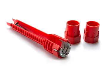 Red pipe wrench isolated on white background. Selective focus.