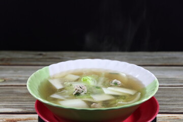 Classic hot clear soup of minced pork and cutting Chinese cabbage serving in the bowl. Famous soft and light menu in Asia restaurant. 