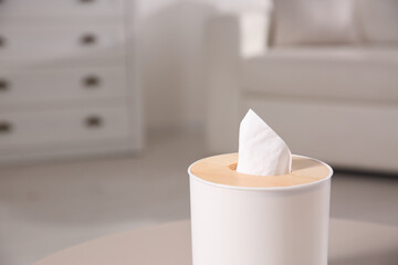 Box with paper tissues on light table in living room, closeup. Space for text