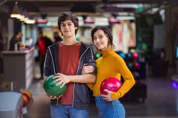 Portrait of young couple in bowling alley.