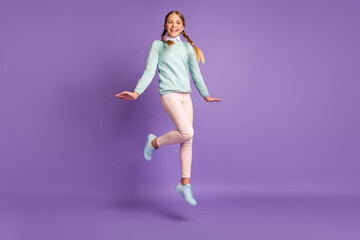 Photo portrait full body view of girl jumping up isolated on vivid purple colored background