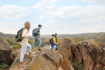 Group of hikers with backpacks at top of mountain