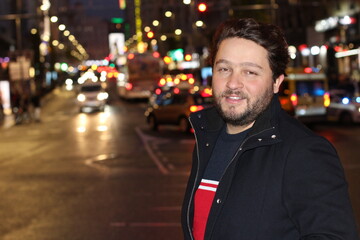 Bearded Caucasian man going out at night