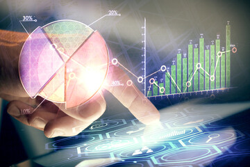 Multi exposure of man's hands holding and using a phone and financial chart drawing. Market...