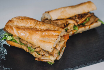 Sandwich de pollo , queso y verduras hecho en pan de baguette