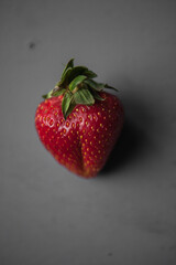 fresh farm strawberries lie on a gray table