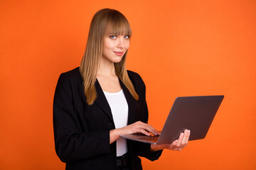 Portrait of pretty focused smart skilled girl copywriter holding in hands using laptop isolated...