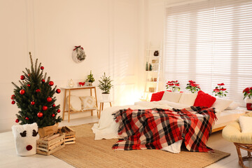 Beautiful decorated Christmas tree in bedroom. Interior design