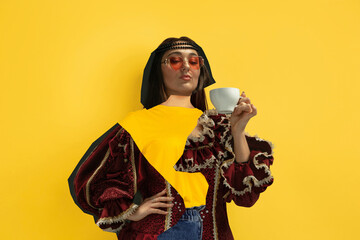 Woman drinking coffee. Magazine style collage with model outfit mixed of different eras. Copyspace for ad. Trendy colors, modern and vintage, renaissansse fashion. Cintemporary art collage.