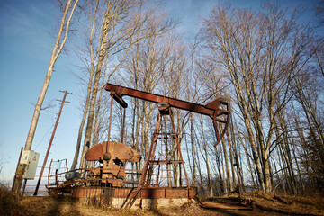 old land oil drilling rig in the forest