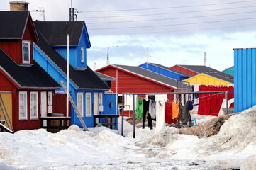 Colorful laundry hangs among colorful houses in Greenland