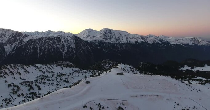 Ski resort summit on the French Alps at Chamrousse during sunrise, Aerial dolly right shot