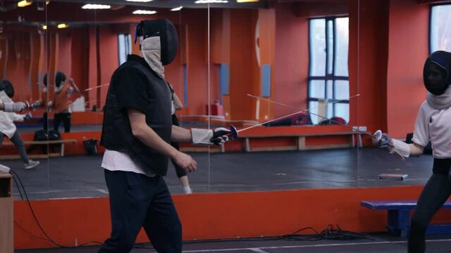Fencing coach working with his student