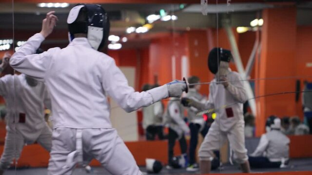 Kids practicing fencing at a fencing school 