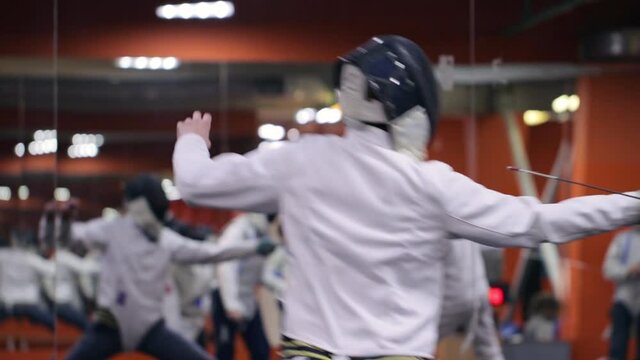 Teenagers practicing fencing at a fencing school 