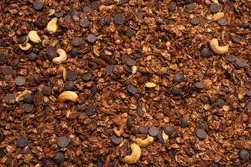 Chocolate granola cereal with nuts background.