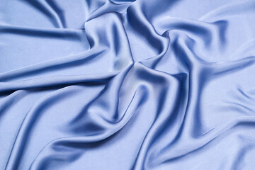 Blue silk or satin luxury fabric texture. Top view.