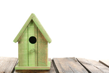Obraz na płótnie Canvas Beautiful green bird house on wooden table against white background, space for text