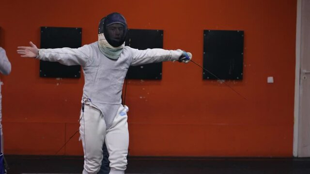 Teenagers practicing fencing at a fencing school 