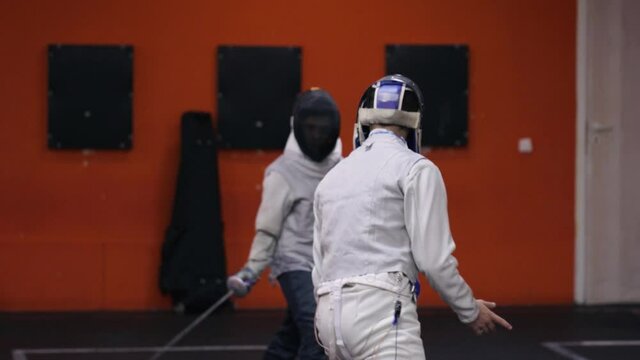 Teenagers practicing fencing at a fencing school 