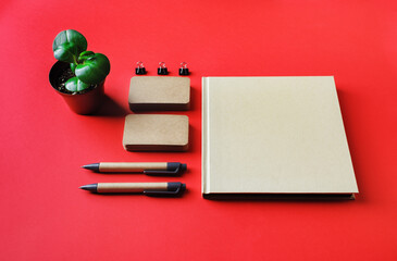 Blank kraft corporate stationery set on red paper background. Corporate identity template....