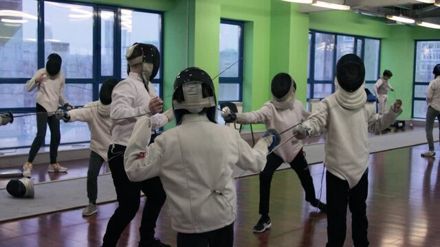 Kids practicing fencing at a fencing school 