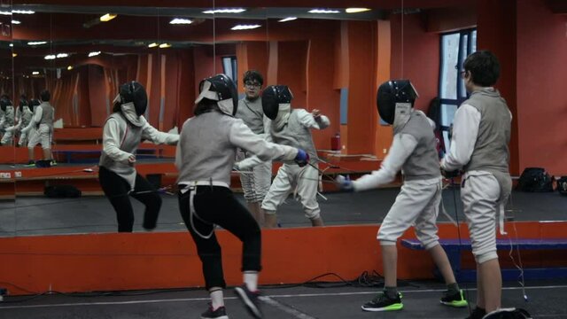 Kids practicing fencing at a fencing school 