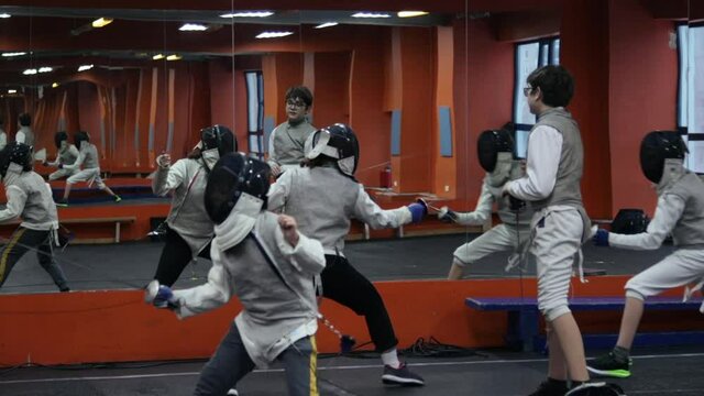 Kids practicing fencing at a fencing school 