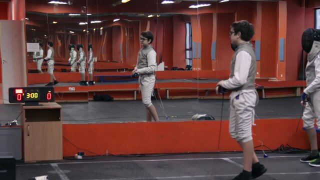 Kids practicing fencing at a fencing school 