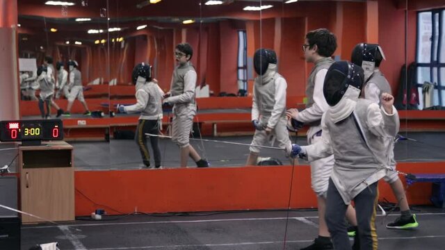 Kids practicing fencing at a fencing school 