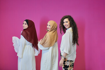 Young muslim women posing on pink background