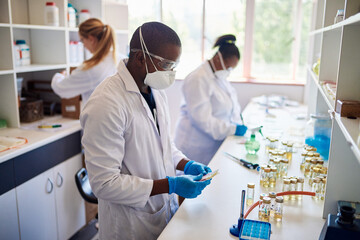 Group of technicians working together with samples in a lab