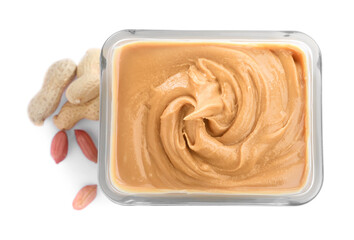 Delicious peanut butter in bowl isolated on white, top view