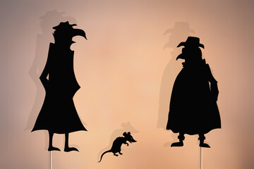 Plague doctors shadow puppets.