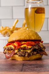 homemade burgers with bell pepper and bacon and fries ready to eat