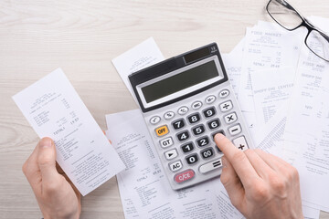 Unrecognizable businessman using calculator on desk office and writing make note with calculate...