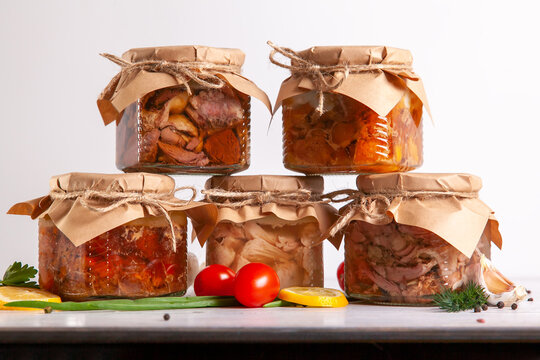 Homemade Canned Meat From Farm Poultry-goose, Duck, Chicken, Pork And Beef. A Pyramid Of Glass Cans With Canned Food